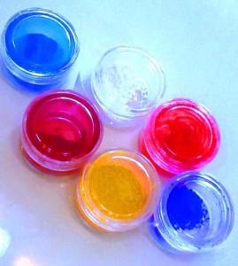 Color pigments for lip, cheek, and eye makeup used in the T-Method course, including highly saturated red, pink, and blue.